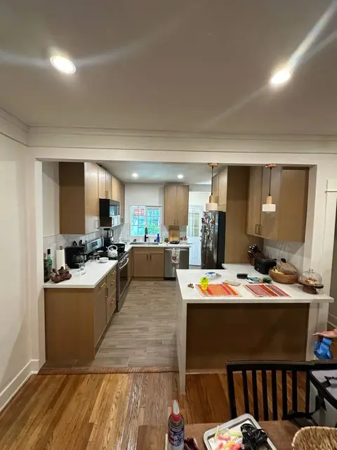 Original kitchen viewed through the dining room opening before renovation