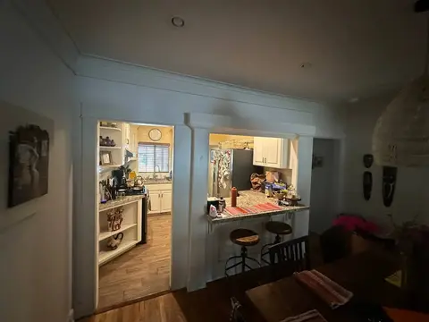 Dining room view into the original kitchen before the opening and cabinetry were remodeled