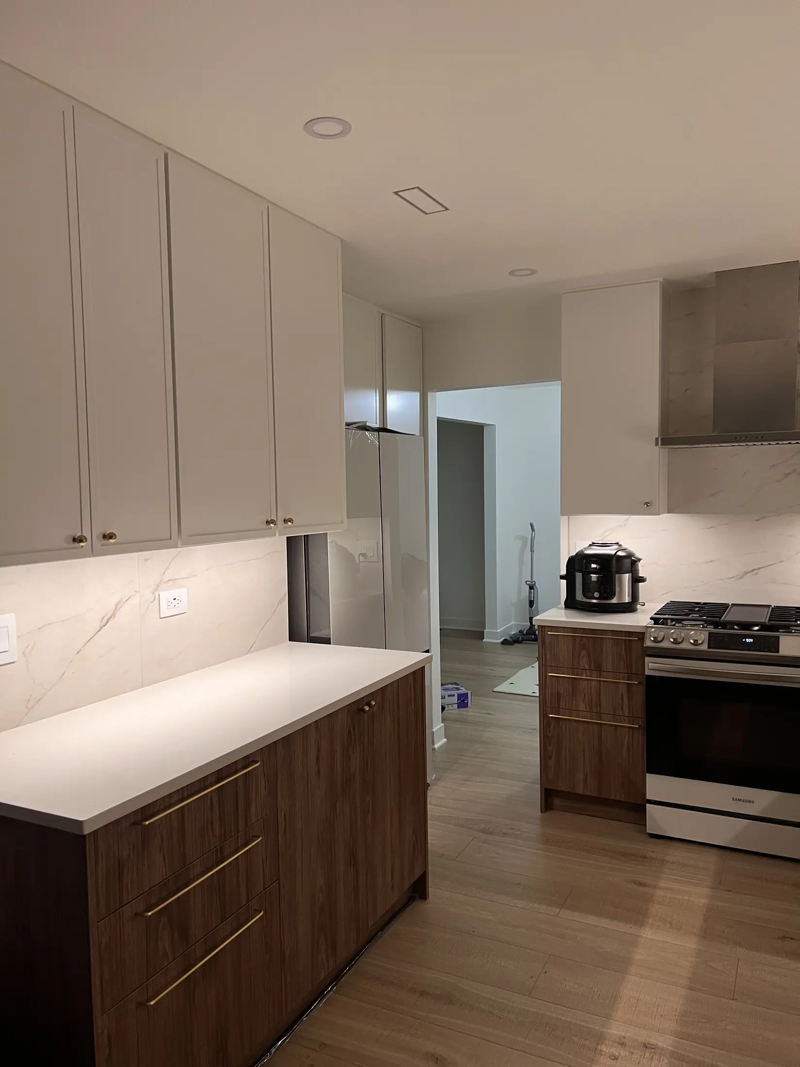 Completed kitchen remodel with two-tone cabinetry and bright work surfaces