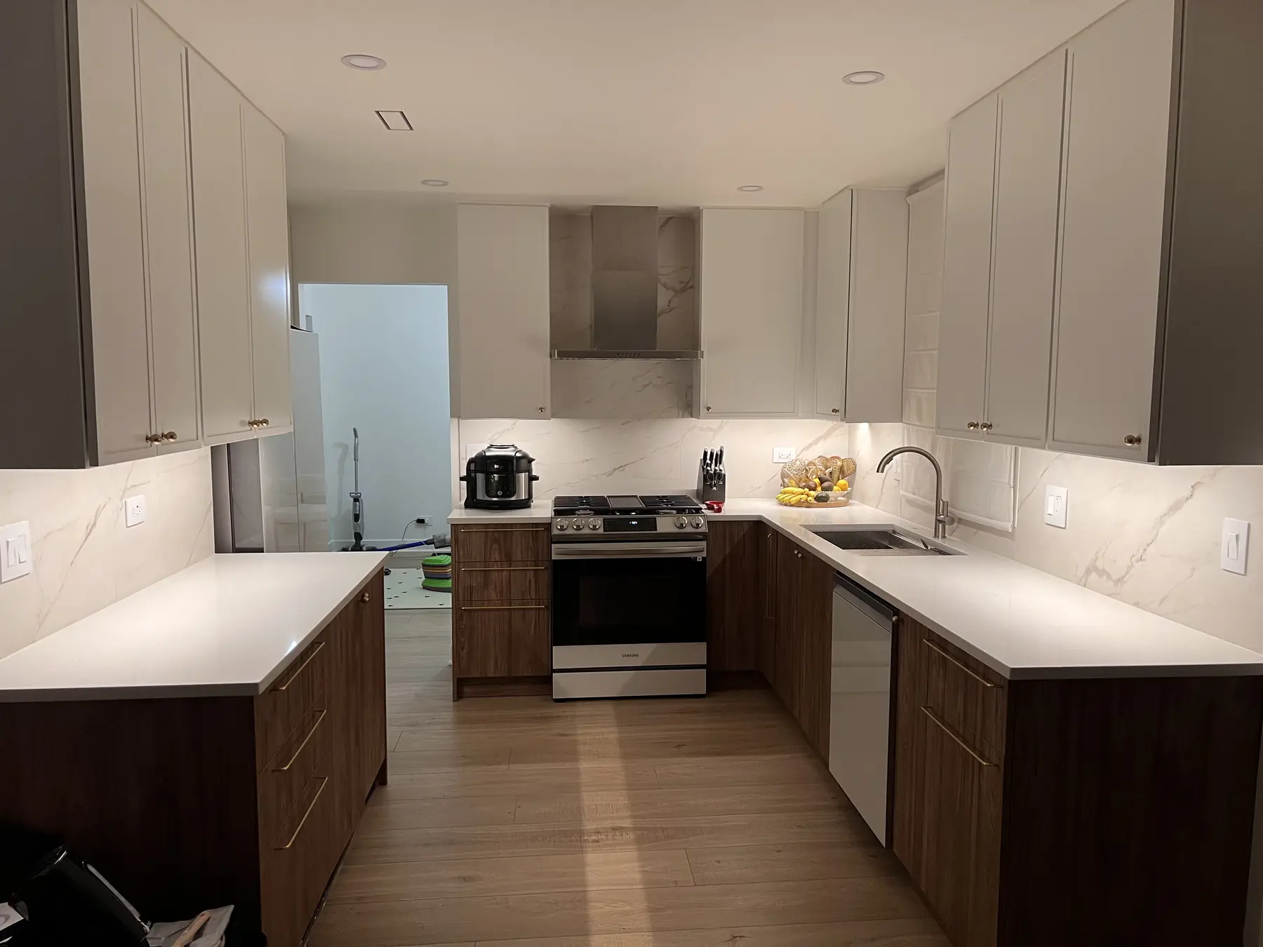 Wide view of the finished kitchen layout with coordinated cabinets and counters